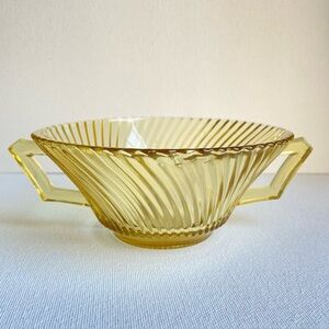 Vintage yellow pressed depression glass bowl with handles and ribbed swirls